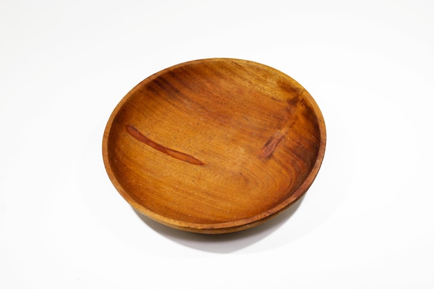 A small wooden bowl with a dark brown interior.