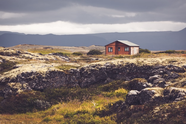 Small wooden cottage in Iceland volcanic landscape