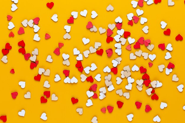 Small wooden hearts on a yellow background. a creative idea. valentine day greeting card