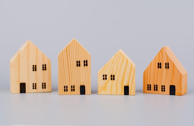 Photo small wooden house toy house model wooden house on a light green background