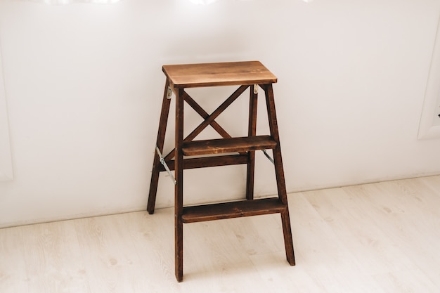 Small wooden stepladder near the window