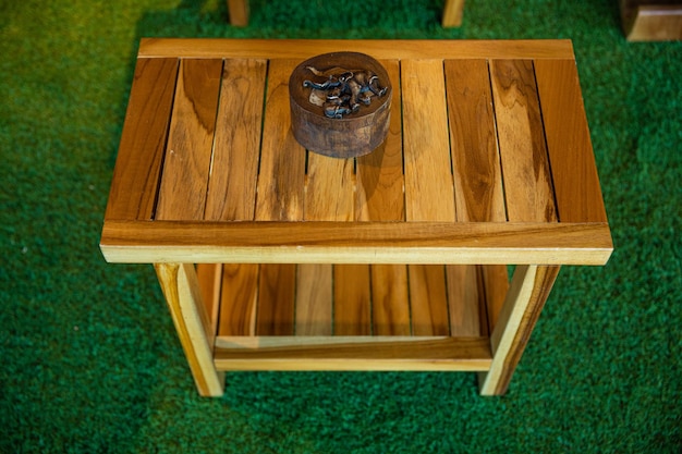 A small wooden table with a box on top of it