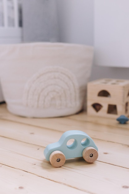 Photo small wooden toy car on the floor