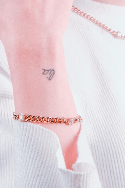 A small wrist tattoo with the word virgo on it.