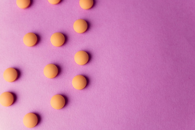 Small yellow orange beautiful medical pharmaceptic round pills vitamins drugs antibiotics