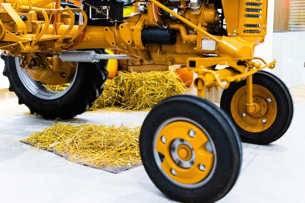Small yellow tractor in exhibition closeup details wheels