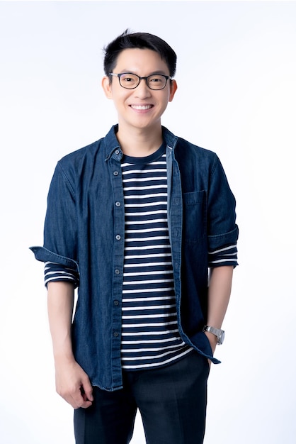 Smart attractive asian glasses male standing and smile with freshness and joyful casual blue shirt portrait white background