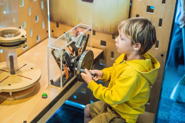 Smart boy scientist making physical experiments in the laboratory Educational concept Discovery