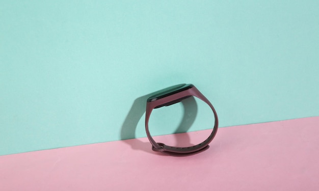 Photo smart bracelet on bluepink background minimalism trendy shadow creative layout