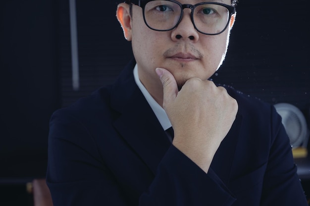 Smart businessman in suit and eyeglasses looking at camera Closeup view