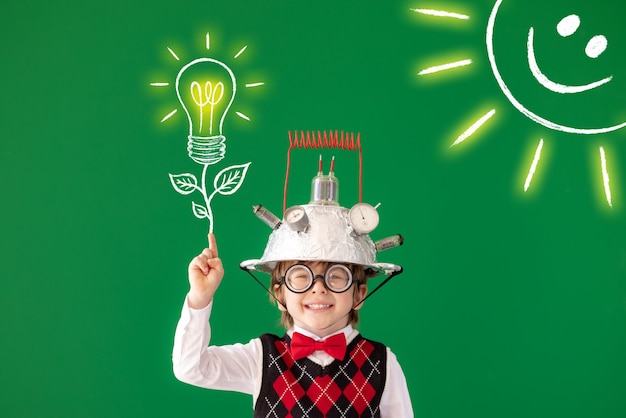 Smart child have an idea Portrait of child against green chalkboard