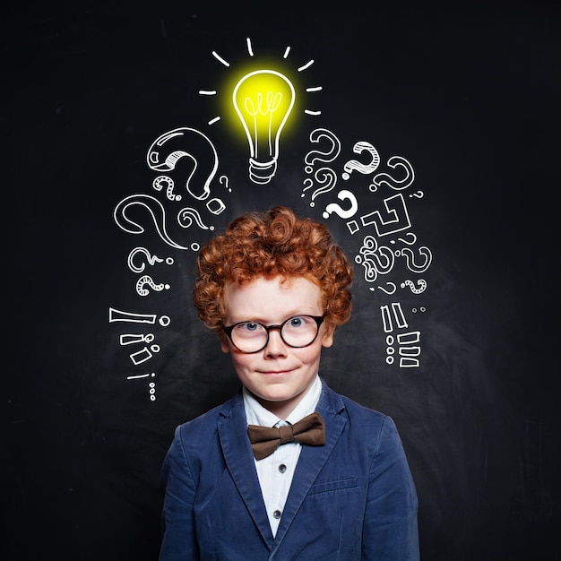 Smart child in school uniform and lightbulb brainstorming and idea concept