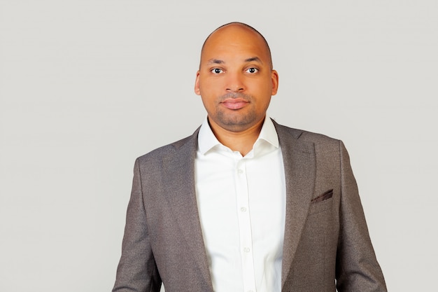 A smart confident black African-American young man, in a shirt and a jacket, a smart look, confident in his success