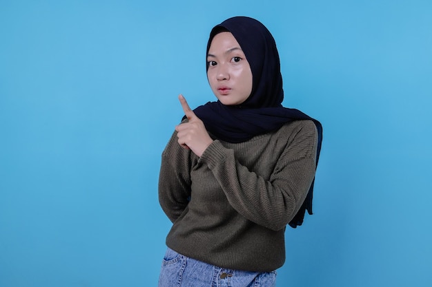 Smart creative serious-looking female coworker thinking deep focus pondering idea making choice touching chin thoughtful look on blue wall