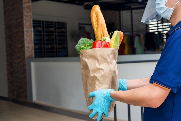 Smart delivery food service man handing food to recipient with woman customer receiving order from courier at home Woker service food shopping online