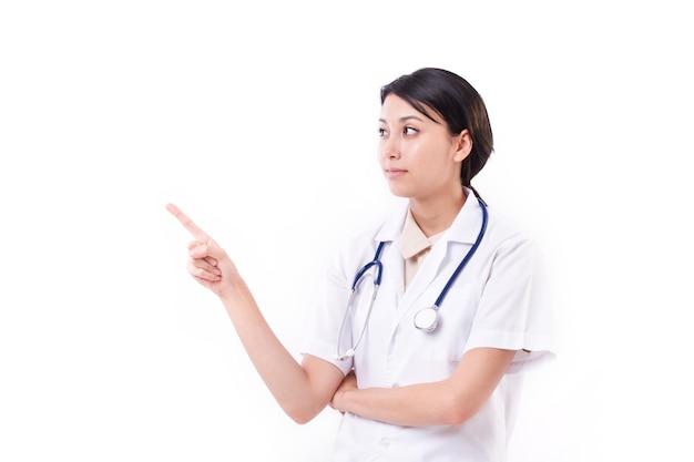 Smart female doctor pointing up to blank space