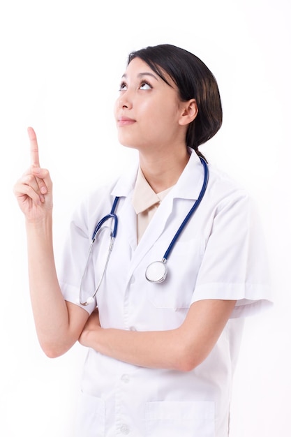 Smart female doctor pointing up to blank space