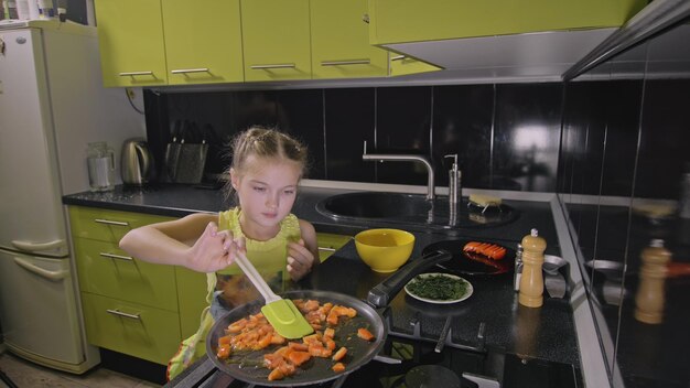 Smart girl learning to cook Young mistress children to cook a Neapolitan egg fried omelette