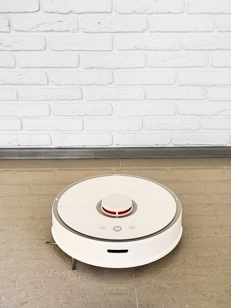 Smart House. Vacuum cleaner robot runs on floor in a living room.