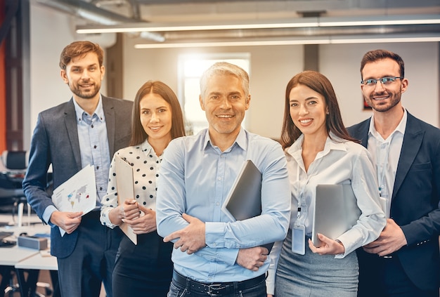 Smart intelligent people posing at the photo front in the office