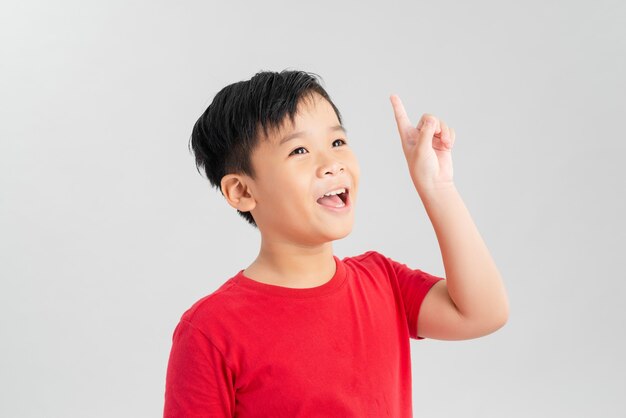 Smart kid in a red t-shirt pointing up