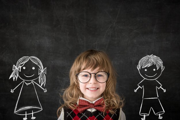 Smart kids in class. Happy children against blackboard. Education concept