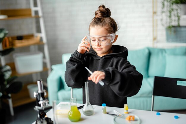 smart little girl doing a chemical experiment