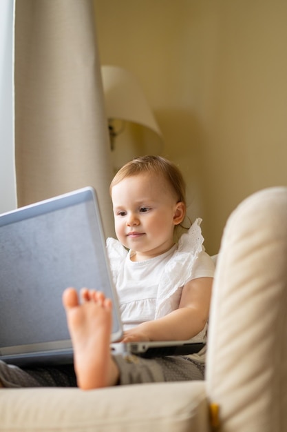 Smart little toddler girl while using her laptop