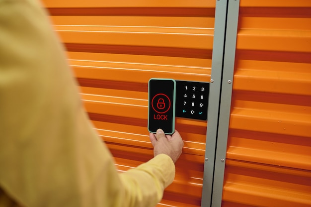 Smart lock. A warehouse worker testing the digital management system