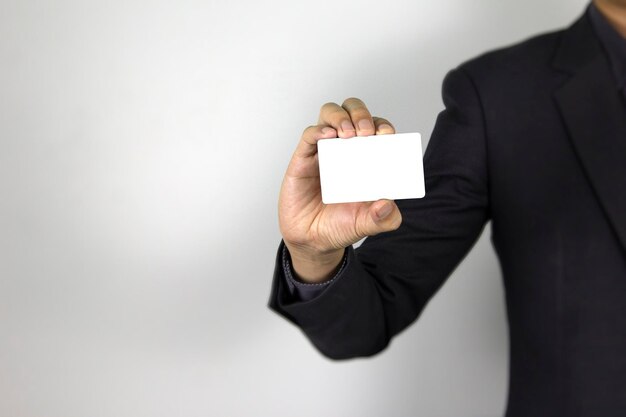 A smart Man holding mockup white card on white background a business man wearing dark suit