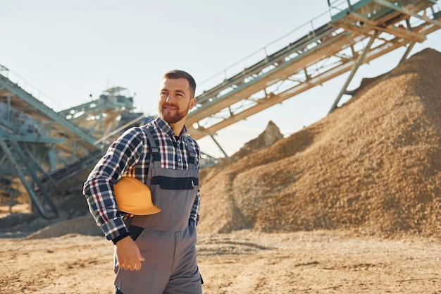 Smart person construction worker in uniform is on the\
quarry