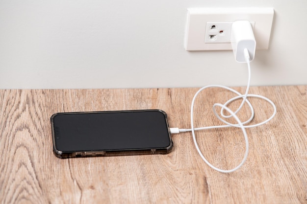 Smart phone charger plugged on wooden with plugged at homex9