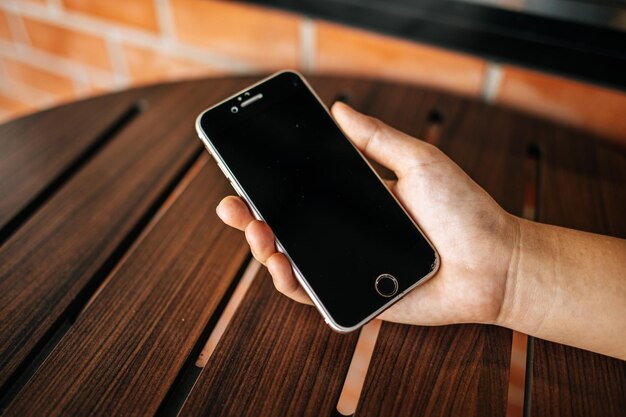 Smart phone on hand with table