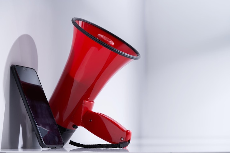 Photo smart phone and megaphone on white background