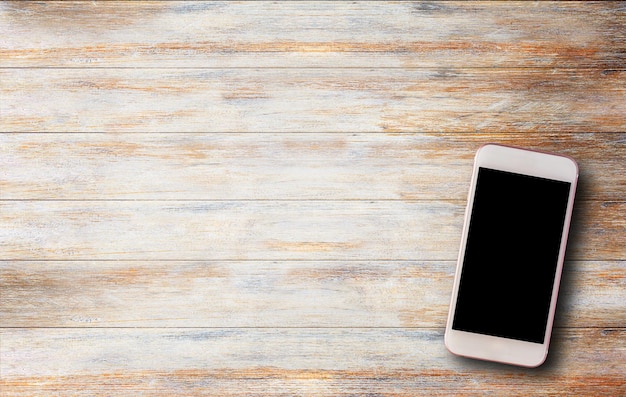 Smart phone on old wooden table