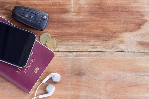 Smart phone and passport on wooden table