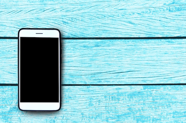 Foto smart phone su fondo in legno pastello