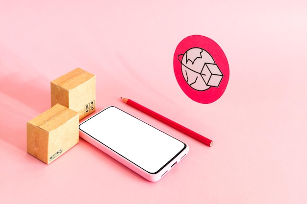 Photo smart phone with blank screen and cardboard boxes on pink background online shopping and global delivery service concept