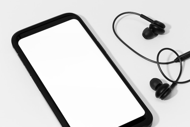 Smart phone with blank screen for mock up Mobile phone and earphones Isolated on white background Template