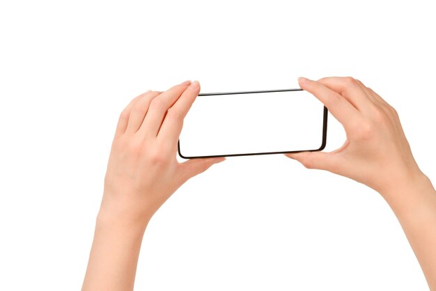 Smart phone in woman hands isolated on white background.  White screen. Copy space.