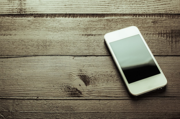 Smart phone on wooden table 