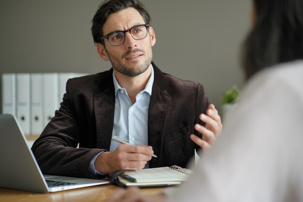  Smart professional male with client in office                                             