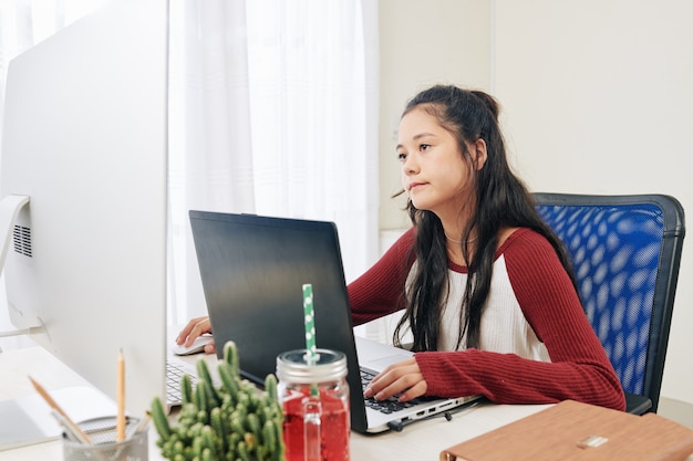 Smart teenage girl programming at home