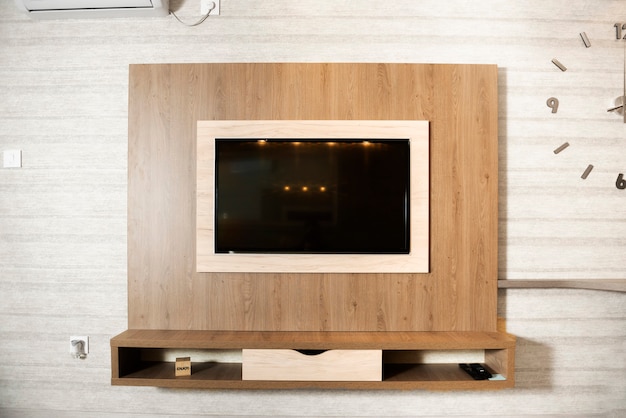 Smart TV in a wooden wall in a cozy apartment