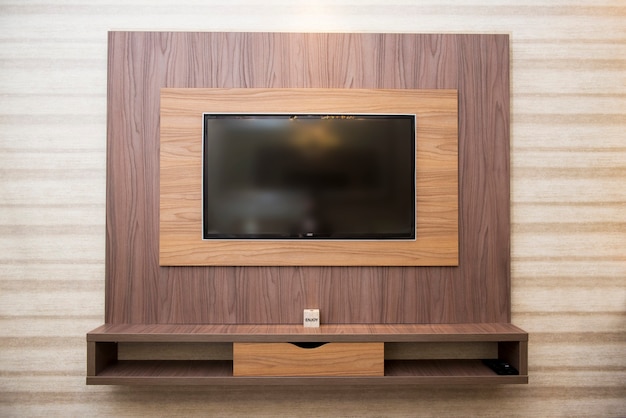 Smart TV in a wooden wall in a cozy apartment