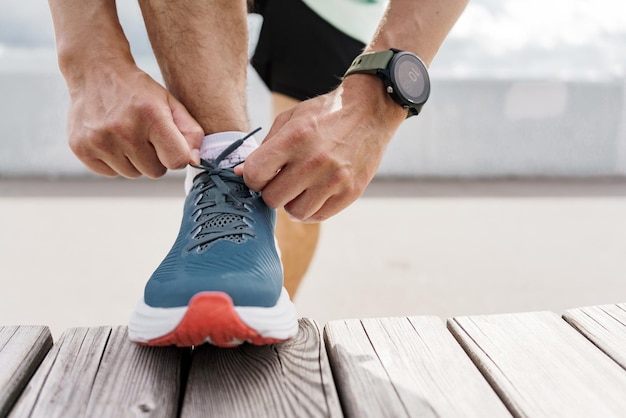 A smart watch for fitness an athlete uses a mobile app and running shoes