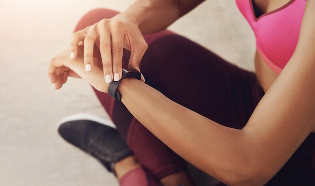 Smart watch fitness and hands of woman in city for exercise training and workout in morning Sports runner and person check time or track heart rate for health wellness and performance outdoors