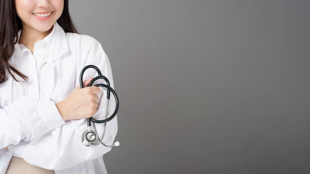 Smart woman doctor is holding stethoscope