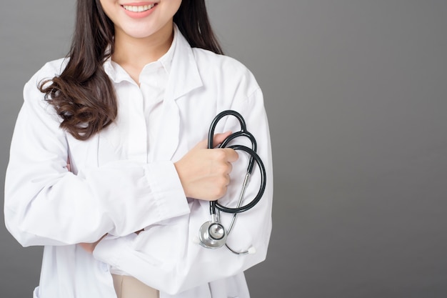 Smart woman doctor is holding stethoscope