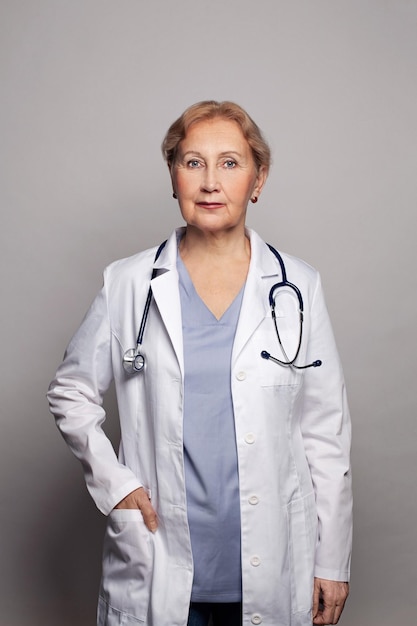 smart woman doctor with stethoscope looking at camera